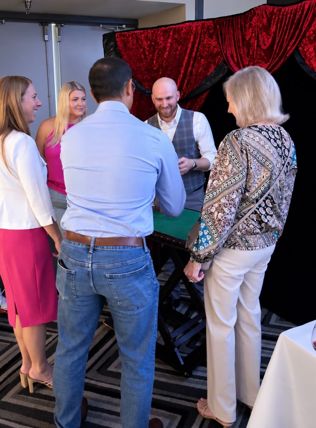 Dylan Looper performing a card trick at a networking event