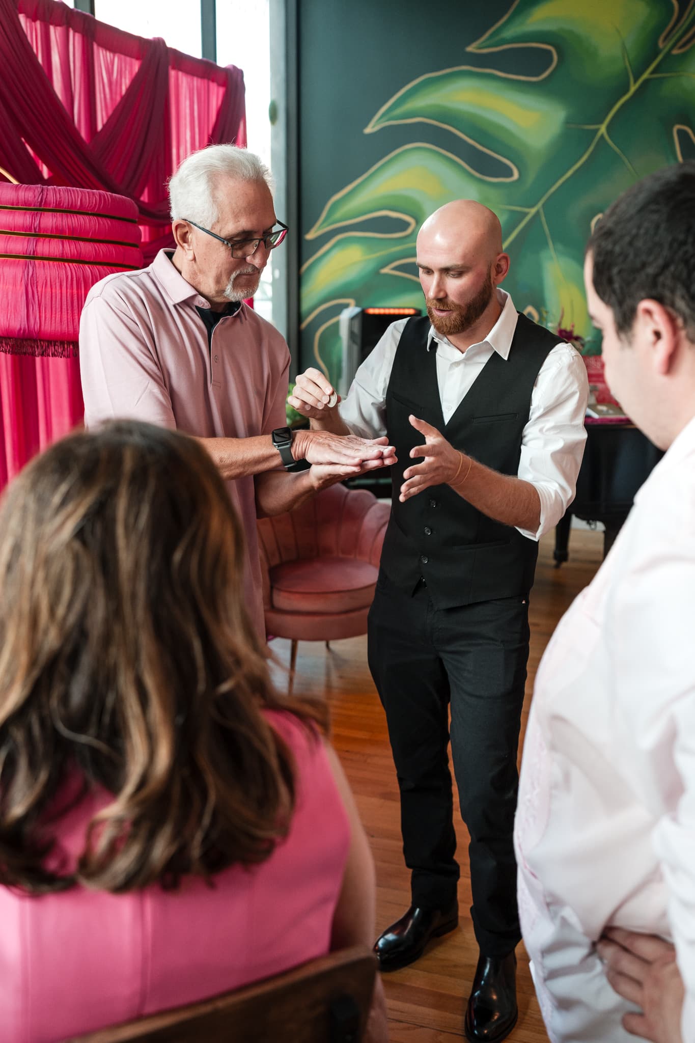 Dylan Looper performing a close-up coin trick for a guest