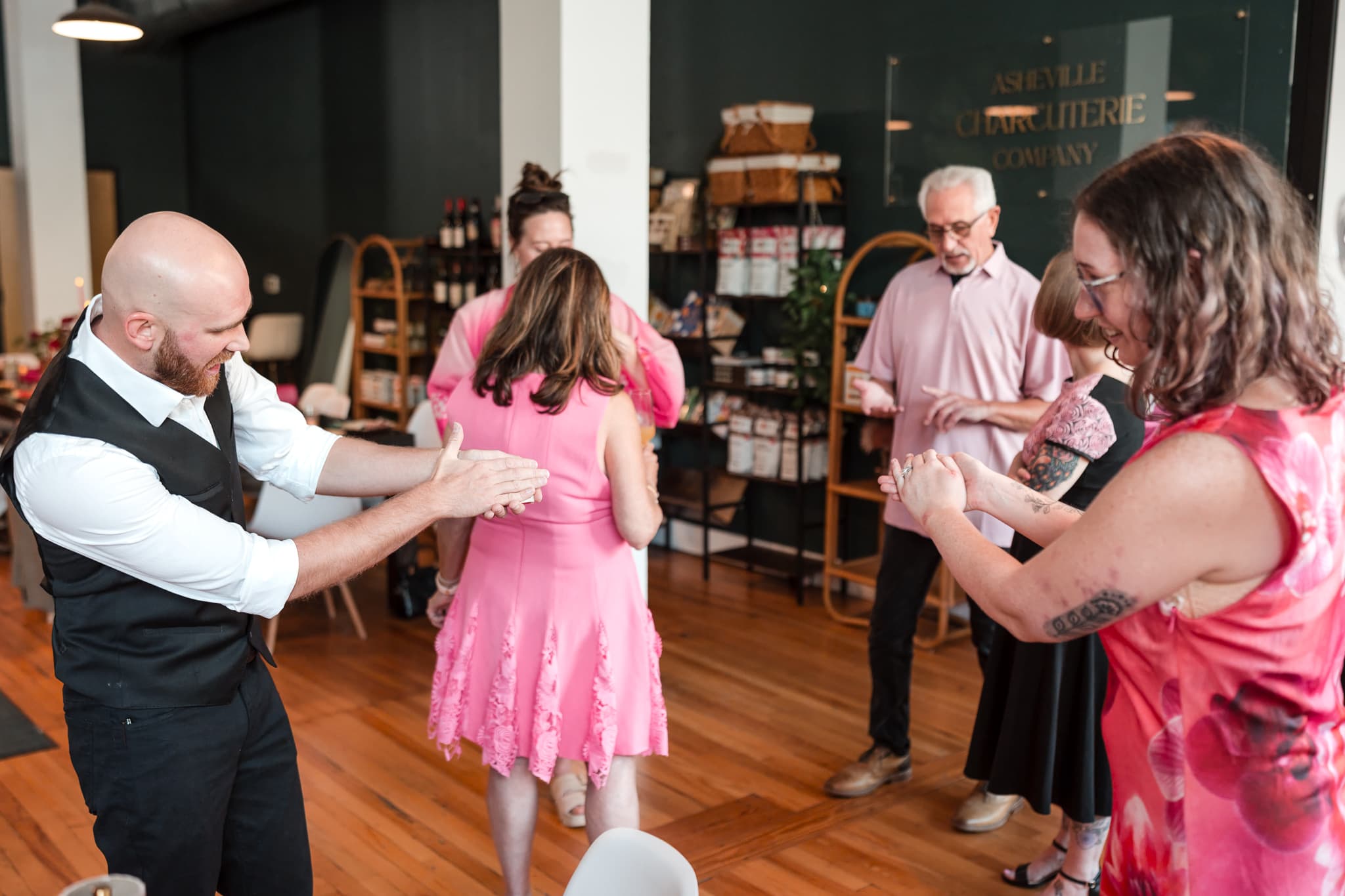 Dylan Looper performing a hand-to-hand magic trick for wedding guests in Asheville, NC