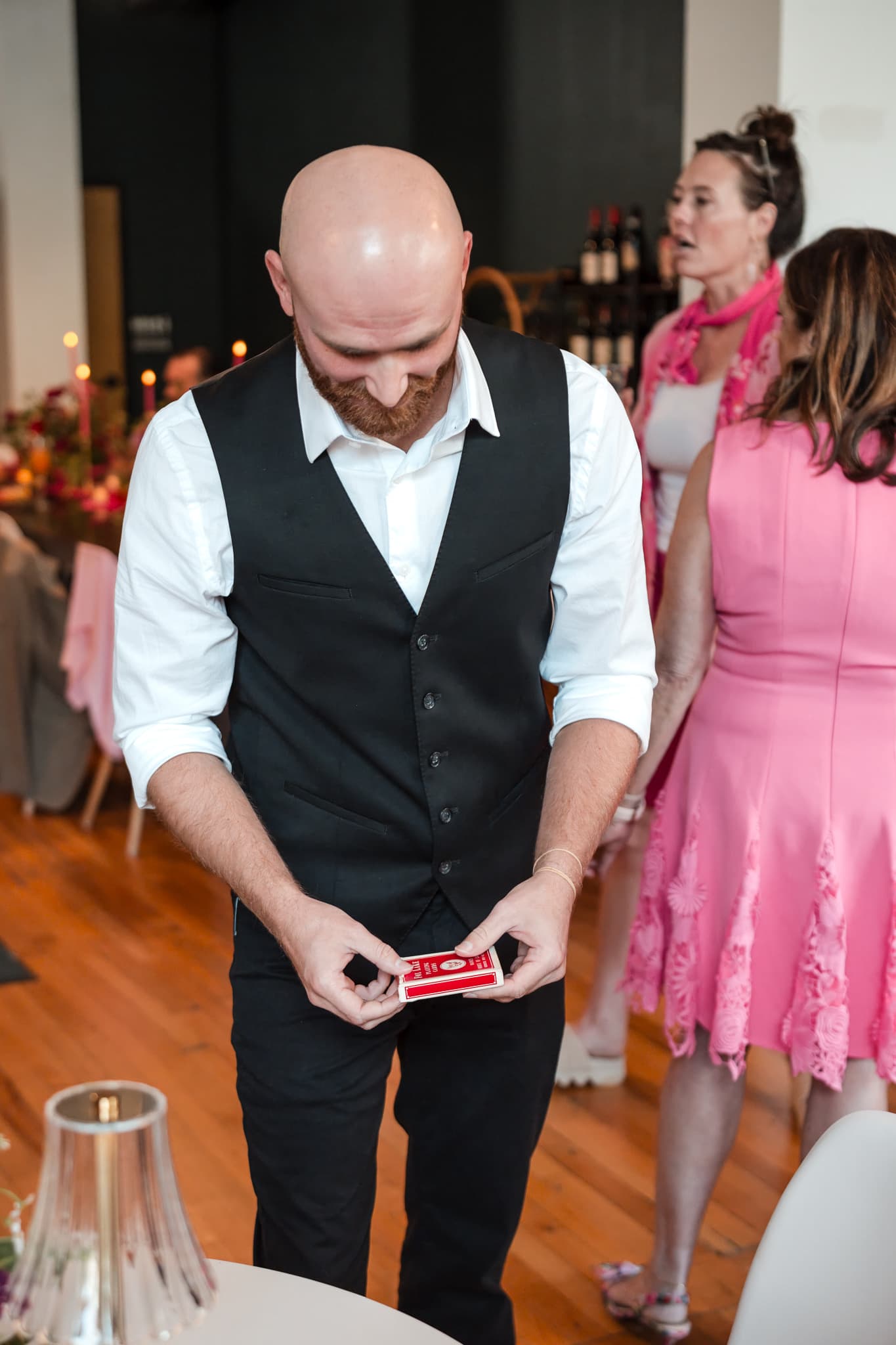 Dylan Looper opening a deck of cards to begin a trick for wedding guests in Asheville, NC