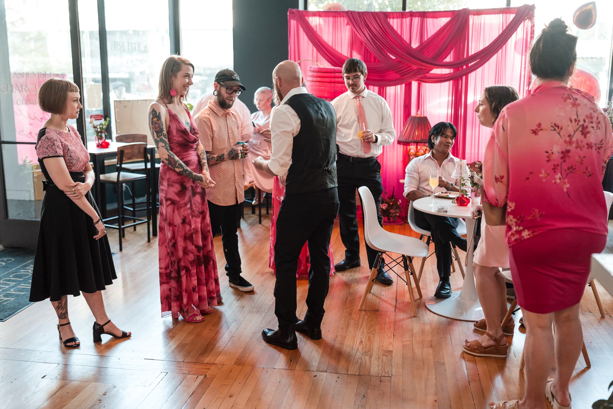 Wedding reception guests gathered around Dylan Looper for close-up magic