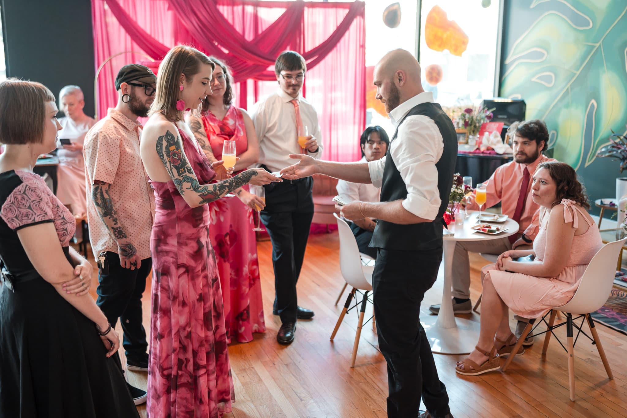 Dylan Looper performing a card trick for wedding guests during cocktail hour