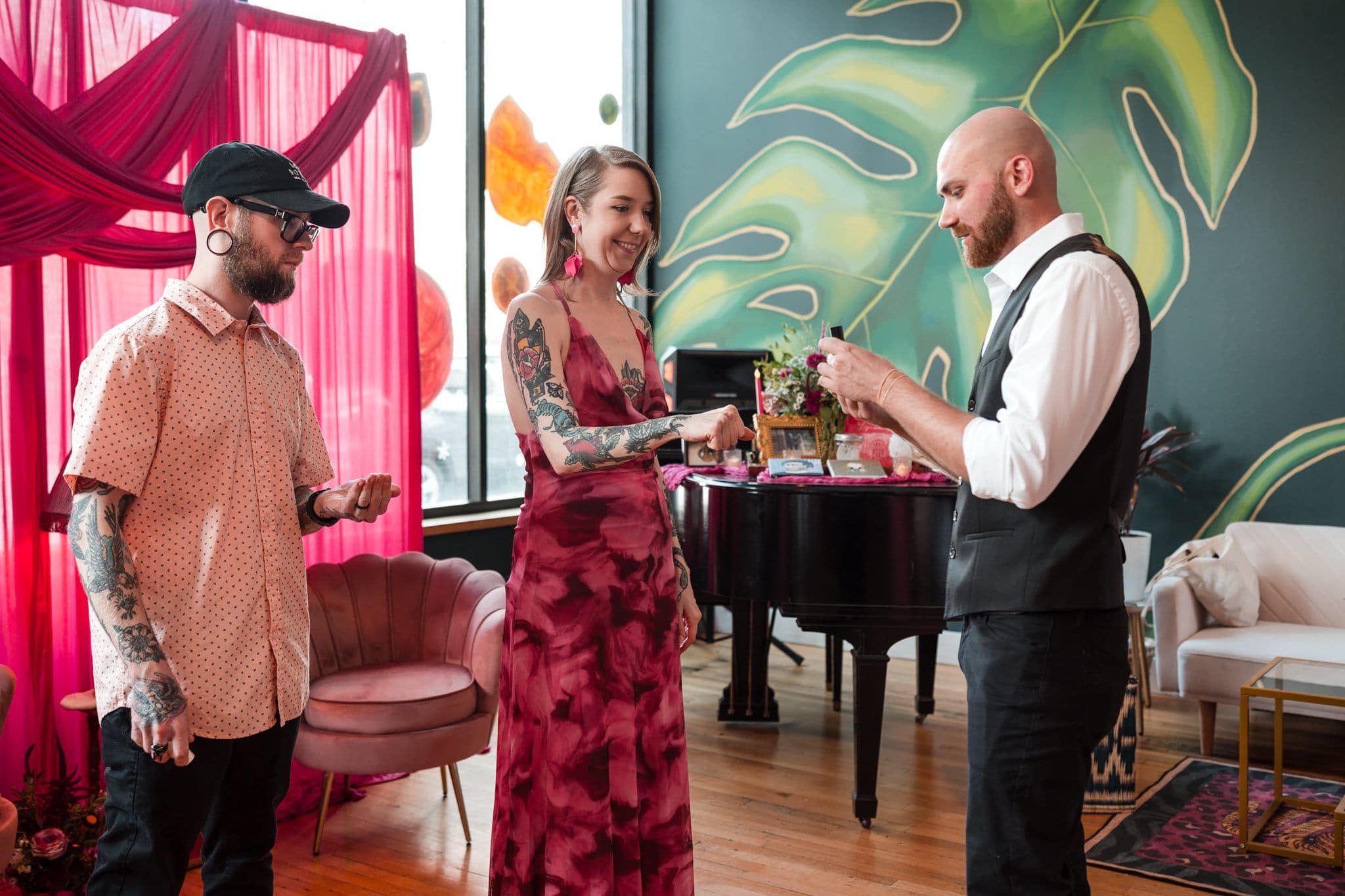 Dylan Looper and wedding guests laughing together during a close-up magic performance