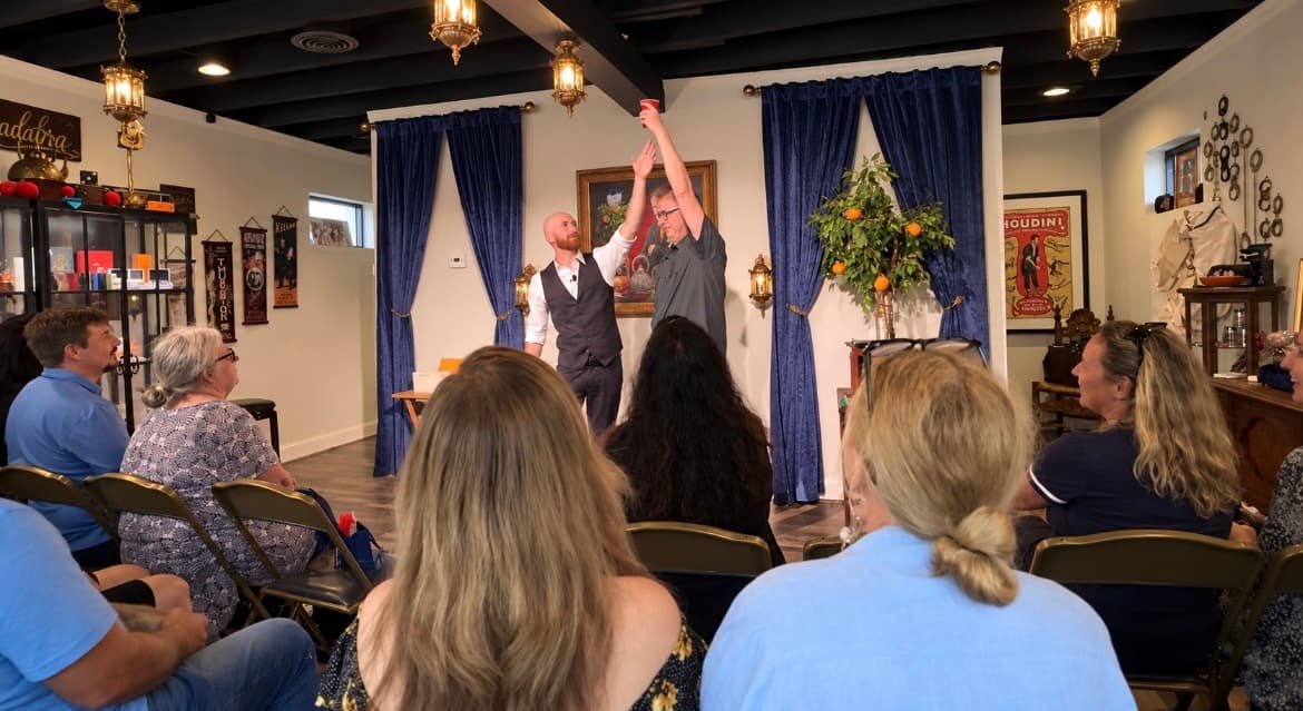 A guest laughing in amazement during a close-up magic reveal
