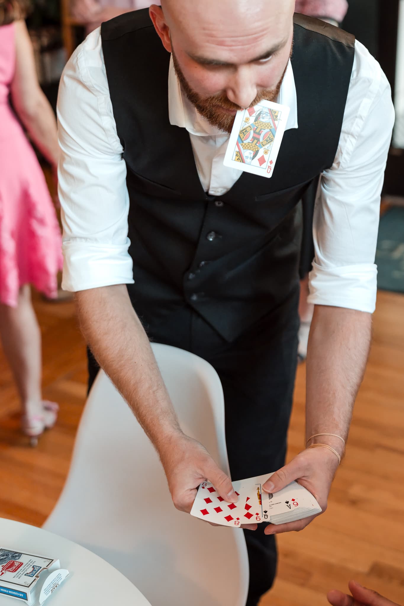 Dylan Looper performing a card trick for guests in Asheville